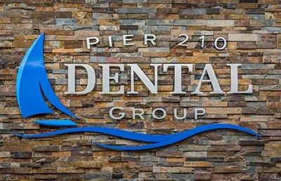 Pier 210 Dental Group sign hanging up in their office