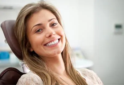 woman smiling during her cosmetic dentistry appointment at Pier 210 Dental Group