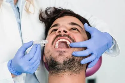 man getting fitted for Invisalign clear aligners